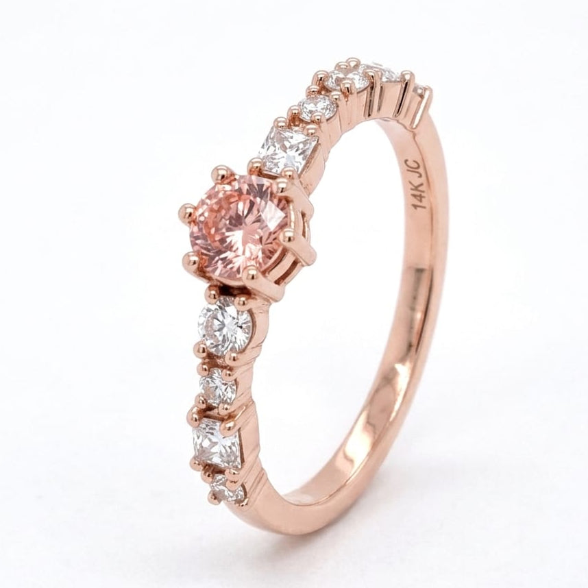 14K rose gold engagement ring featuring a round pink diamond center stone with sparkling white diamond accents, custom designed by JC Fine Jewelry