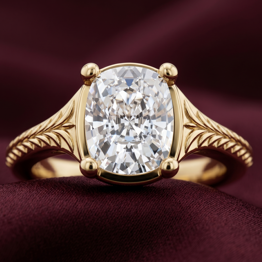 Front view of cushion cut solitaire engagement ring in 14K white gold featuring a large sparkling cushion cut diamond and detailed leaf engraving on the band