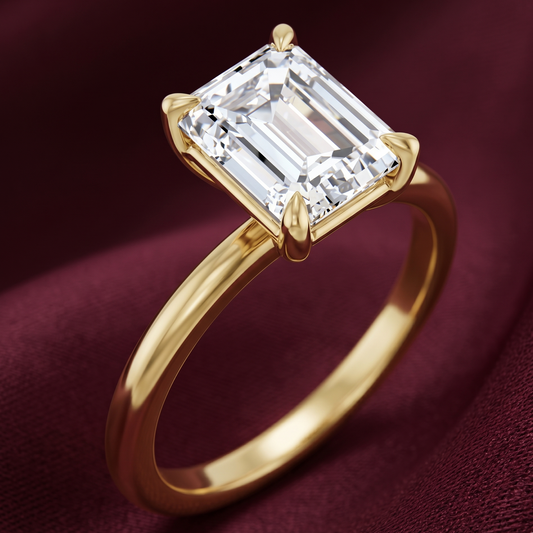 Emerald cut solitaire engagement ring in 14K yellow gold featuring a 2.50 CT emerald cut lab-grown diamond in E color and VVS2 clarity