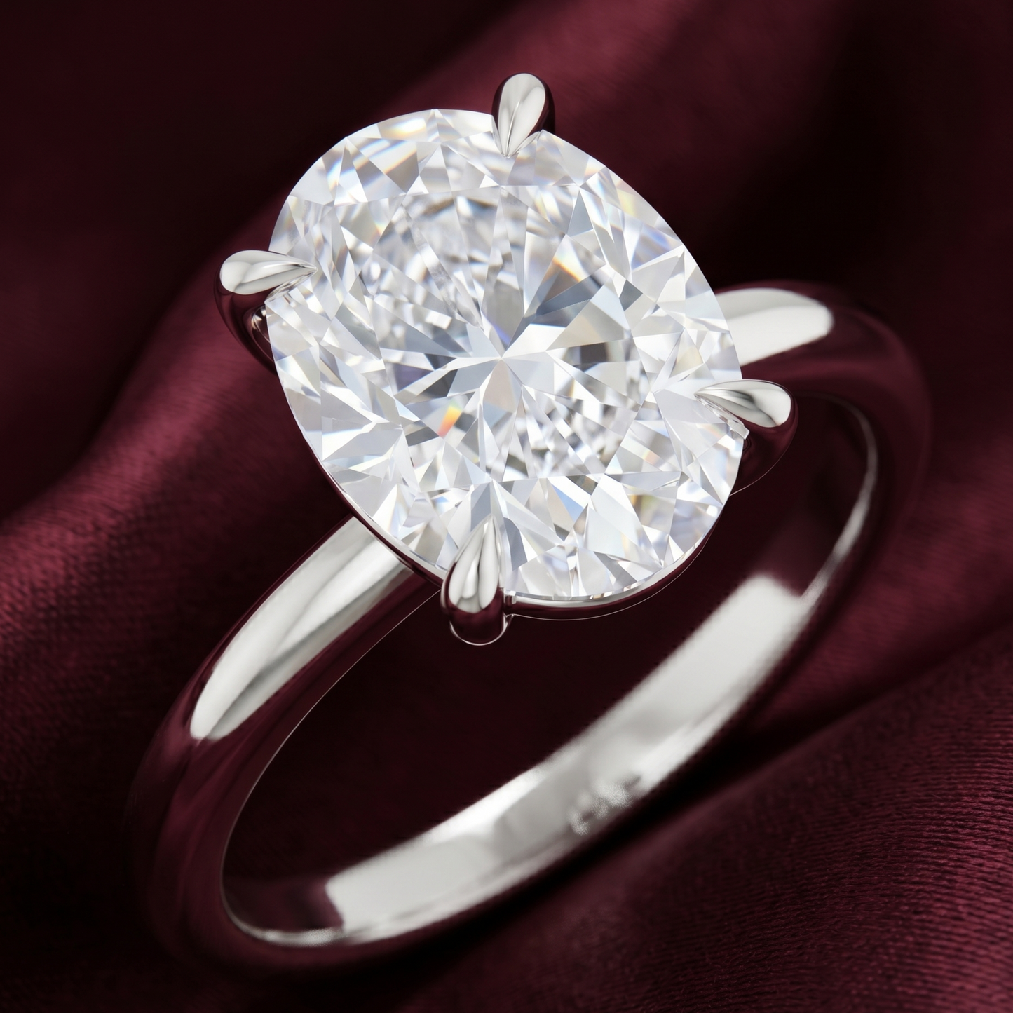 Oval solitaire engagement ring in 14K white gold with a stunning 2.70 CT oval lab-grown diamond, shown against a rich burgundy background