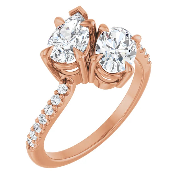 Side view of pear and oval two-stone engagement ring in 14K rose gold showing the elegant side-by-side diamond design