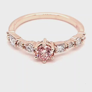 360-degree view of a stunning custom 14K rose gold engagement ring with a vibrant pink diamond center and white diamond accents, crafted by JC Fine Jewelry