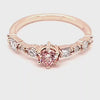 360-degree view of a stunning custom 14K rose gold engagement ring with a vibrant pink diamond center and white diamond accents, crafted by JC Fine Jewelry