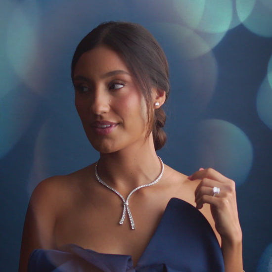 Woman wearing 14K white gold Cascade of Diamonds Necklace with 26.2 total carats, showing beautiful movement and sparkle in a lifestyle setting