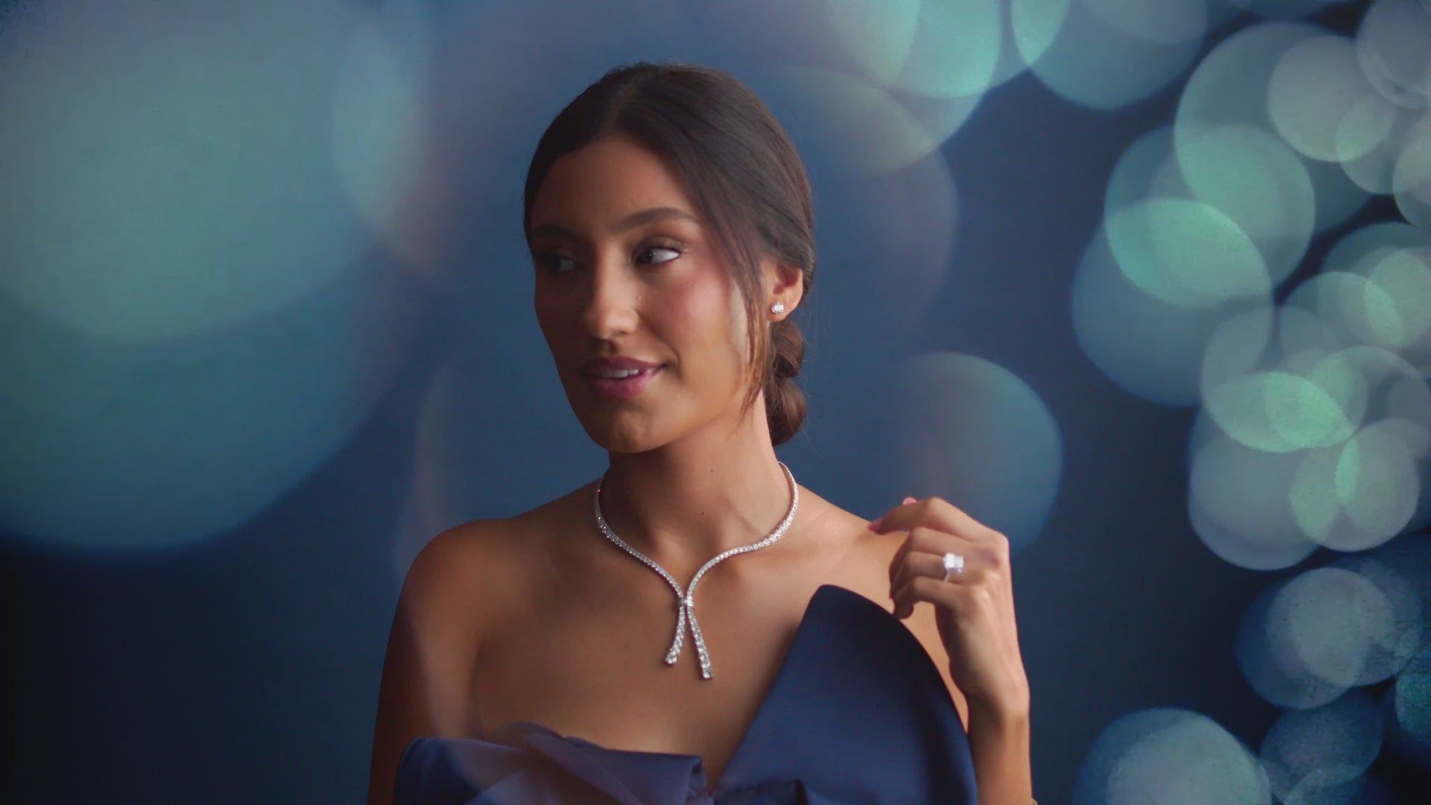 Woman wearing 14K white gold Cascade of Diamonds Necklace with 26.2 total carats, showing beautiful movement and sparkle in a lifestyle setting